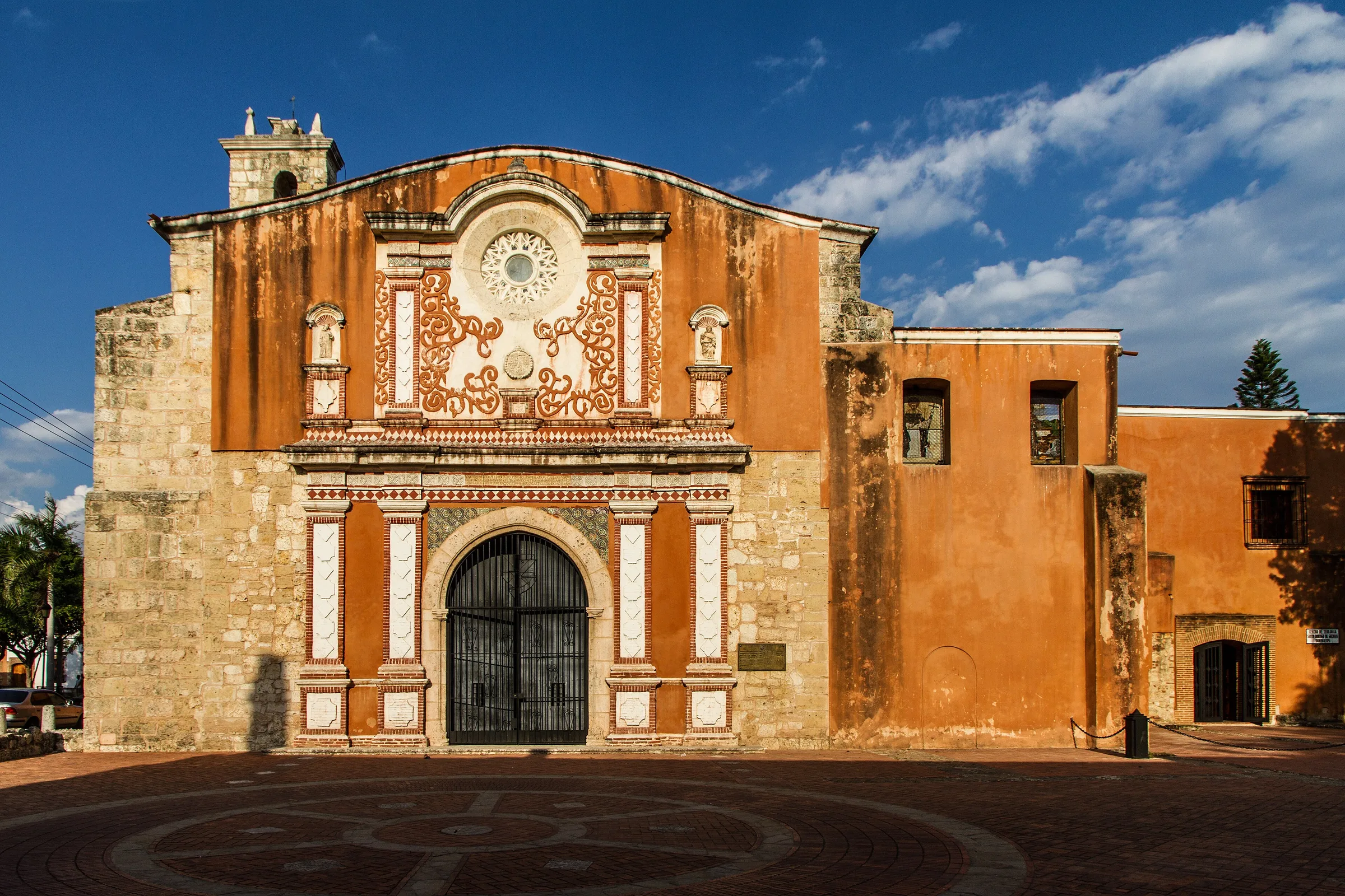 The carved stone facade of the Convento de los Dominicos in late afternoon light